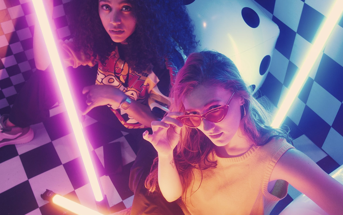 urban-girls-between-bars-of-colored-light